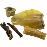 Pieces of mixed beef snacks and chews for dogs on a white background