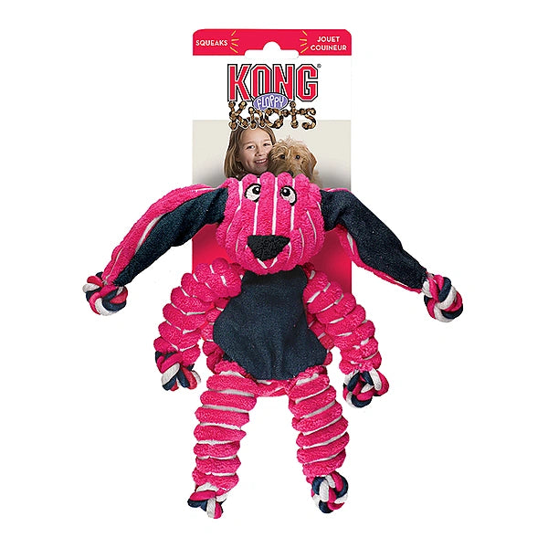 Pink and black dog toy with packaging featuring a child and dog on a white background
