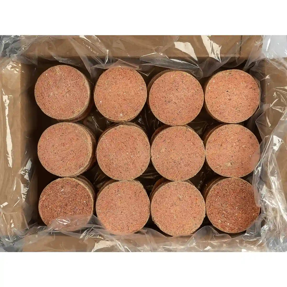 Packaged raw dog food shaped in patties in a clear plastic wrap