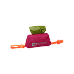 Pink pet waste bag holder with green bag and orange clip on a white background